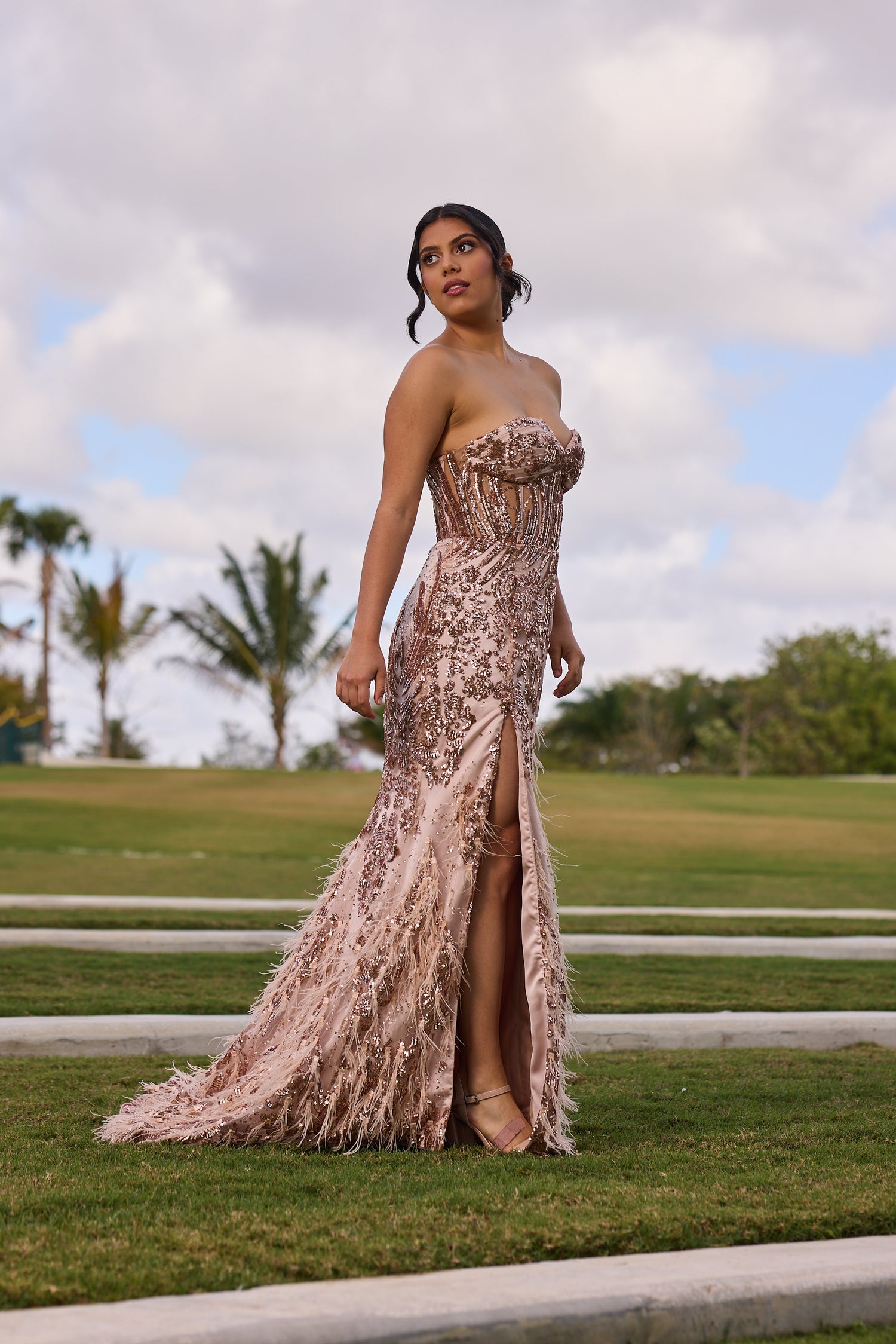Woman in a strapless, sequined evening gown, design by Alexas