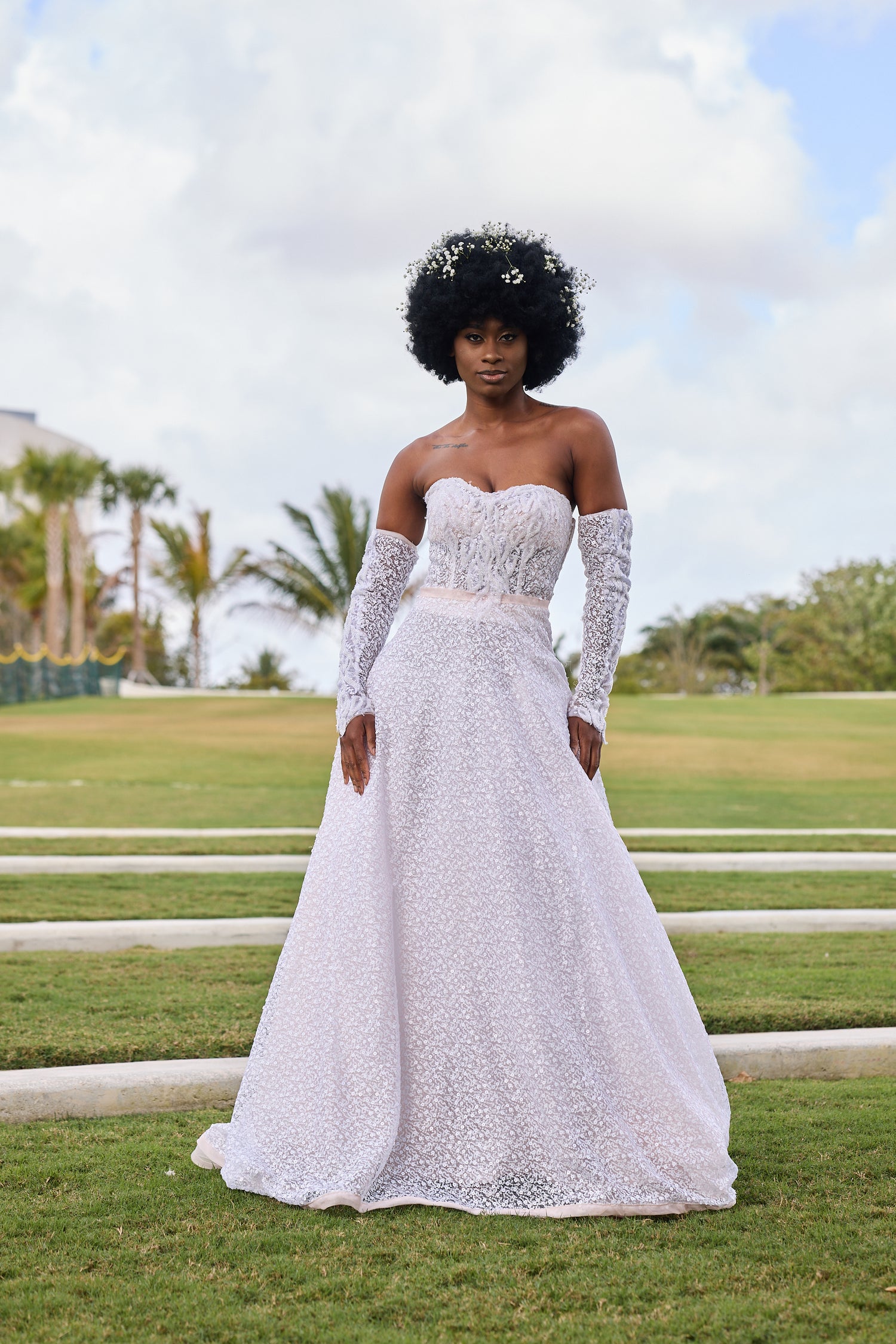 Woman in a white lace wedding dress, design by Alexas