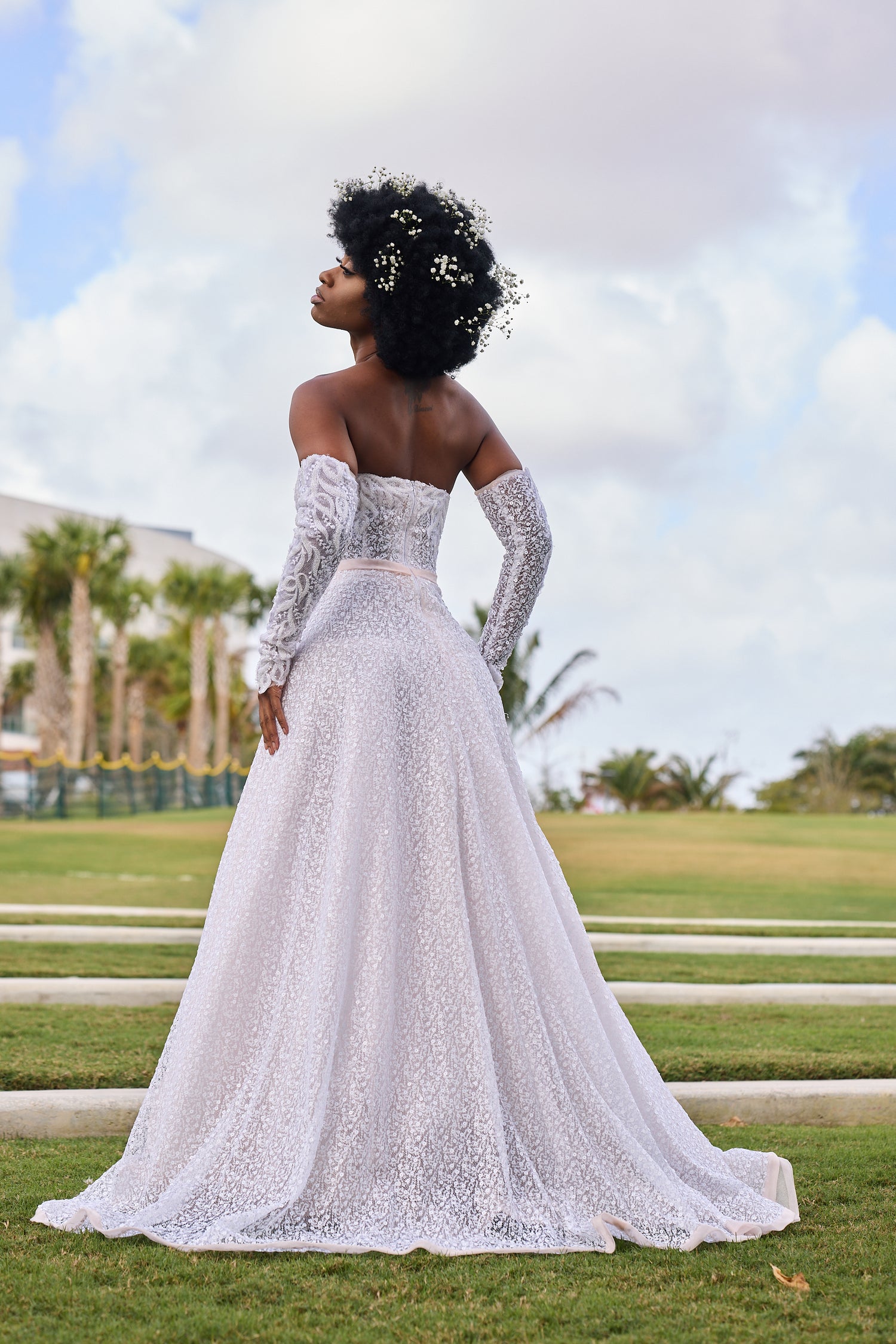 Woman in a white lace wedding dress, design by Alexas