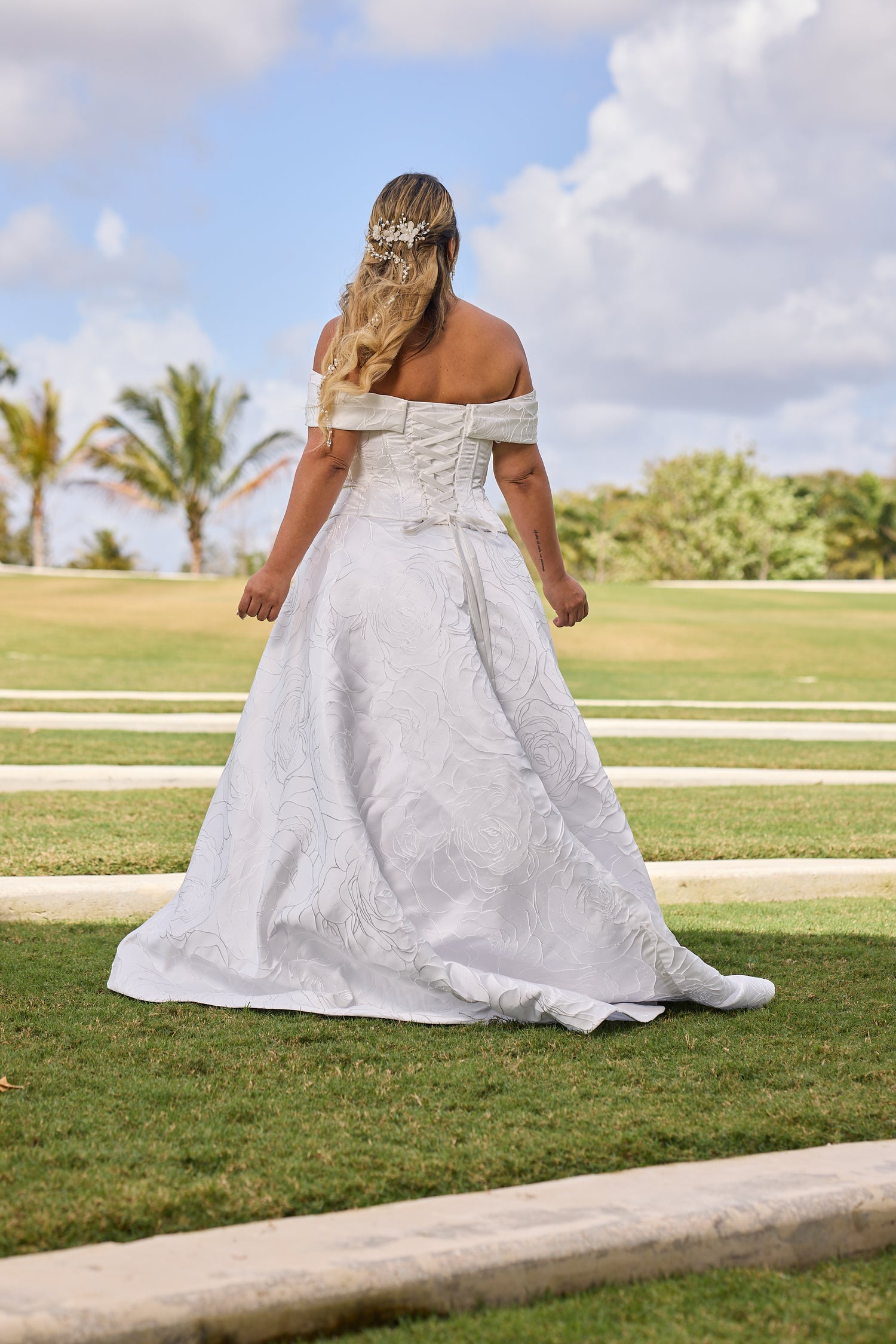 Woman in a white off-shoulder dress, design by Alexas