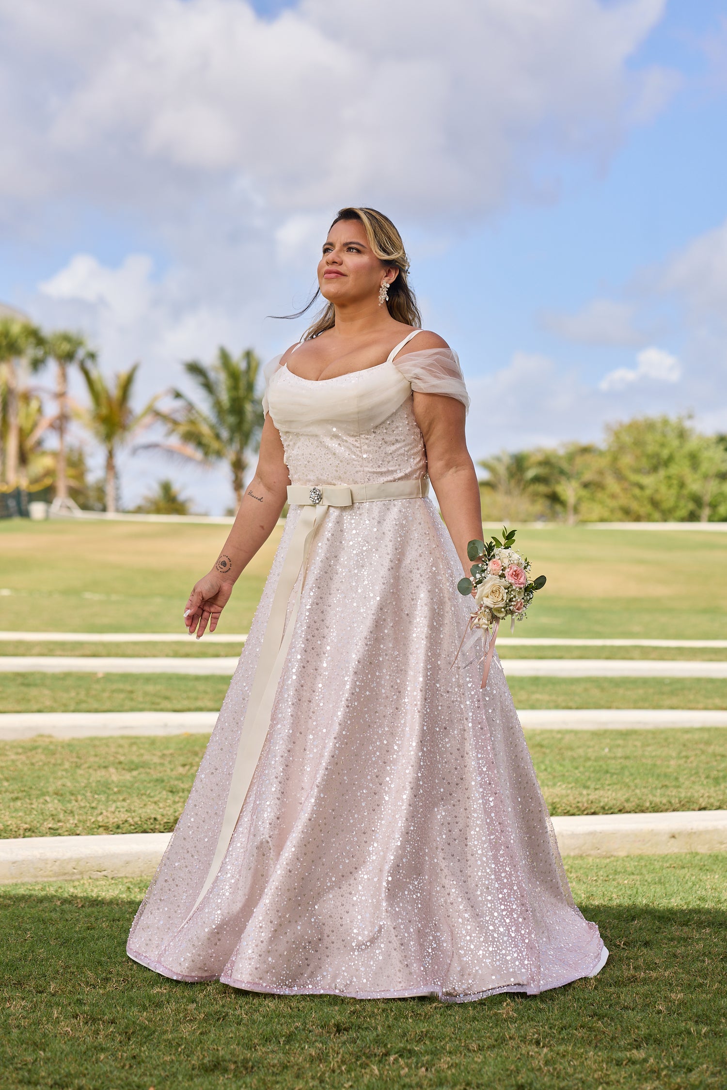 Woman in a white and gold wedding dress, design by Alexas