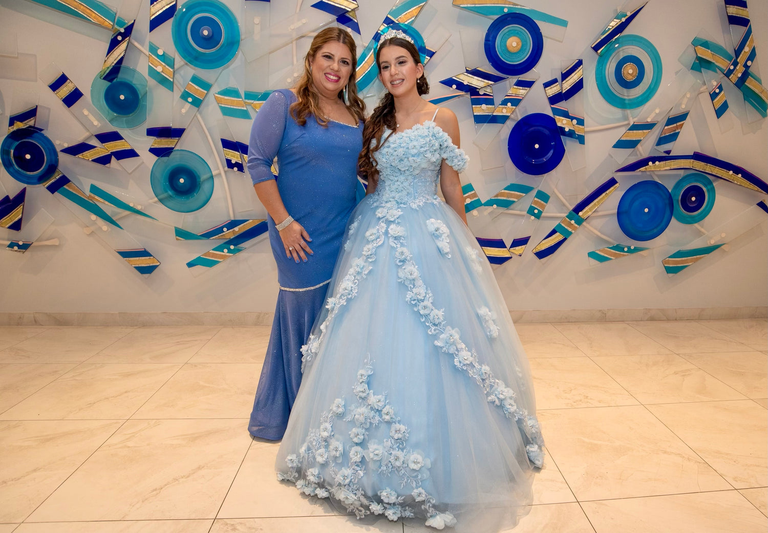 Two women in formal dresses designed by Alexas