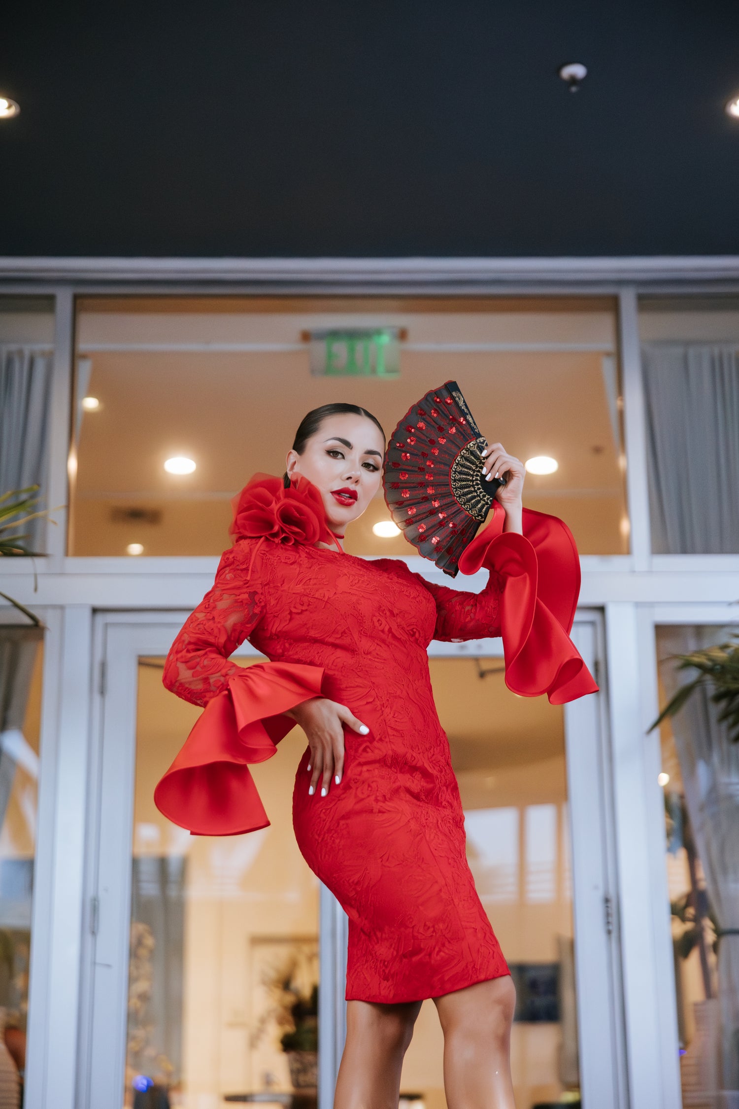 Woman in a red dress designed by Alexas